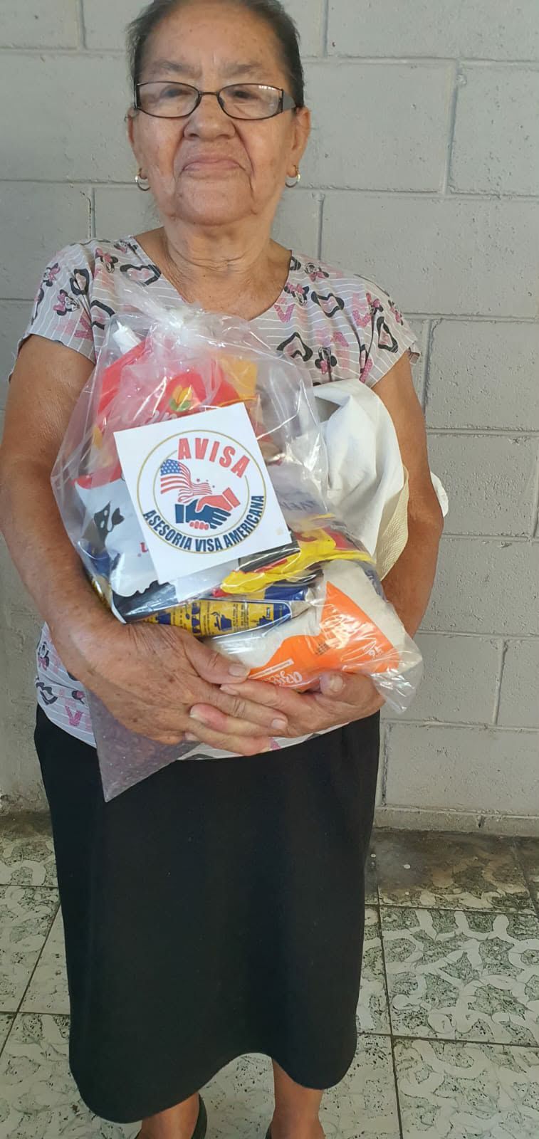 Recipient holding a delivered food support package