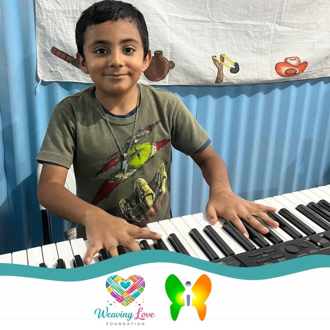 Youth participant holding a foundation page beside a keyboard